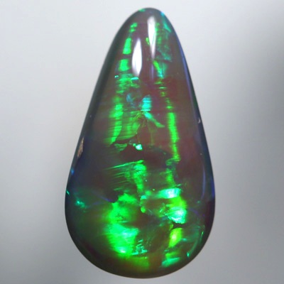SOLID SEMI BLACK OPAL Chasing rolling flashes through greens and turquoise